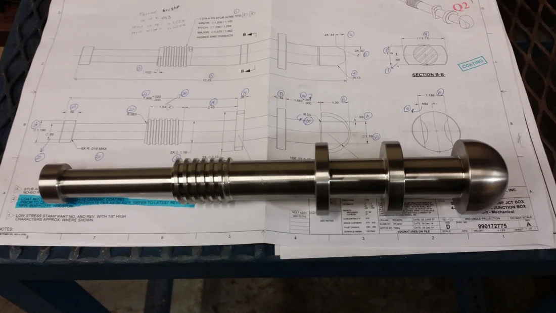A custom machined component with a technical drawing